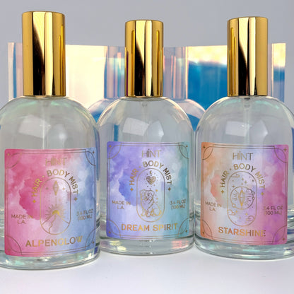 Three bottles of HINT body mist with colorful labels on a white background