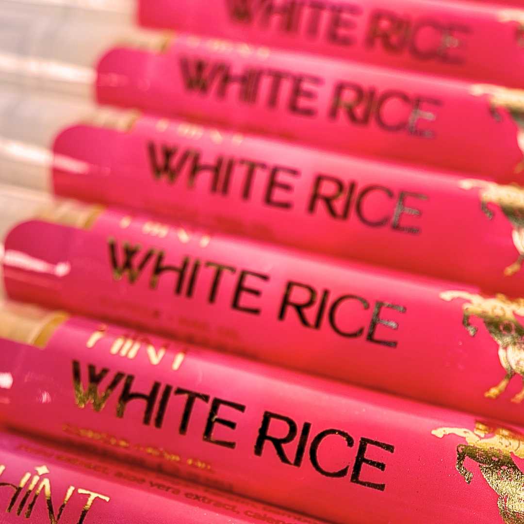 Multiple cuticle oil twist pens of 'White Rice' with a red label 